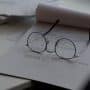 black framed eyeglasses on top of white printing paper